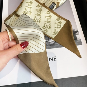 Detail of vintage horse pattern silk scarf with elegant diagonal textures and silk luster