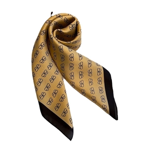 Elegant mustard yellow silk square scarf featuring black butterfly prints and dark borders