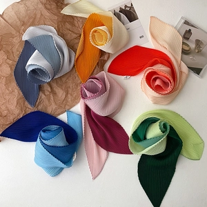 Detailed macro view of colorful pleated skinny scarves with elegant accordion textures