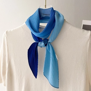 Blue gradient pleated skinny scarf with rhombus ends on white knitwear