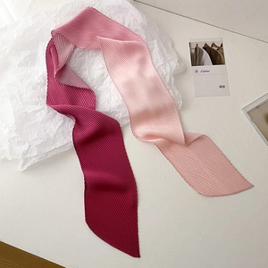 Detail of pleated skinny scarf showing soft gradient transitions and delicate texture