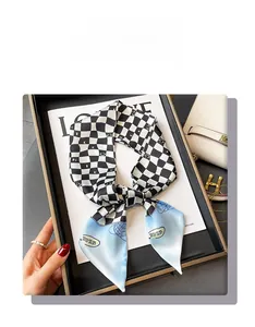 Close-up of checkerboard silk scarf with blue gradient ends and nice lettering detail