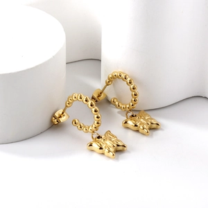 18K gold-plated C-shaped ball hoop earrings with textured butterfly charms on white props