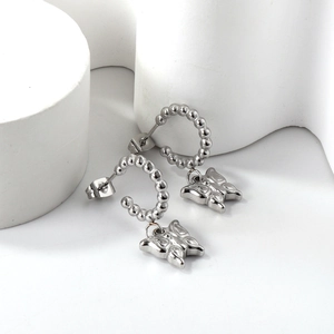 Silver stainless steel C-shaped hoop earrings with detailed butterfly charm pendants