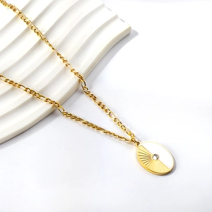 Detailed shot of 18K gold plated oval pendant with white enamel and center zircon