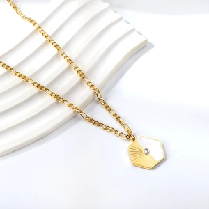 Detailed macro view of hexagonal pendant with mother of pearl and sunburst sun pattern