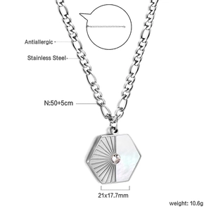 Detail of 18K gold plated stainless steel hexagonal pendant with shell and zircon