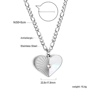 Detailed view of heart pendant with shell inlay, diamond accents, and Figaro chain specs