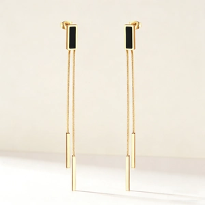 Long gold-plated tassel earrings with black shell inlay and minimalist dangles