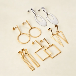 Set of minimalist geometric gold and silver stud earrings in various shapes