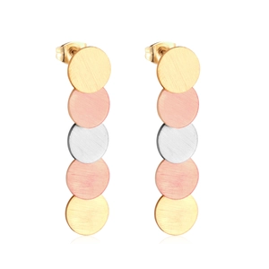 Detailed macro of triple-tone stainless steel drop earrings with brushed texture
