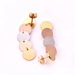 Detailed view of layered geometric round disk earrings in gold, silver and rose gold