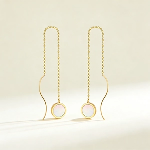Elegant long gold chain tassel earrings with shell heart detail and S-curve design