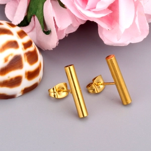 Minimalist cylindrical 18K gold plated stainless steel stud earrings on a natural background