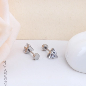 Macro view of triangle-cut clear zircon stud earrings with silver screw-back closure