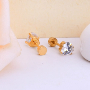 Macro view of heart-shaped crystal stud earrings with gold plating and prong setting