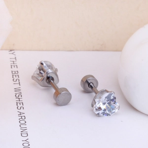 Macro detail of silver heart-shaped zirconia earrings with a secure screw back design