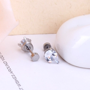Close-up of round and pear-cut zircon stud earrings with silver screw-back design