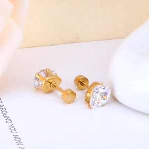 Detailed close-up of gold stud earrings with round cubic zirconia in four-prong setting