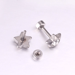 Macro detail of star-shaped stainless steel screw back earrings with central zircon stone