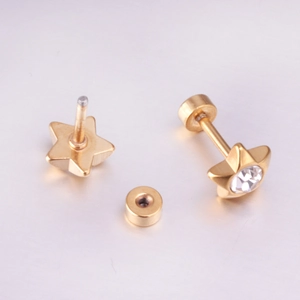 Close-up of gold star earrings with round cubic zirconia and screw-on flat backs