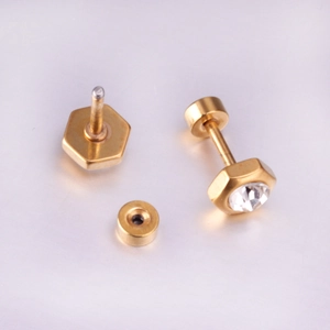Detail view of gold hexagonal stud earrings with clear zircon and screw back closure