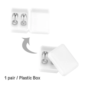 Macro view of silver stainless steel dumbbell studs with zircon and plastic box