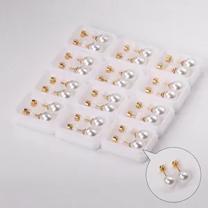Minimalist white pearl stud earring set with gold pins, 12 pairs in display cases