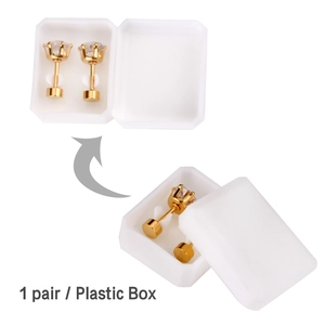 Detail of gold claw-set round cubic zirconia stud earrings in a white plastic gift box