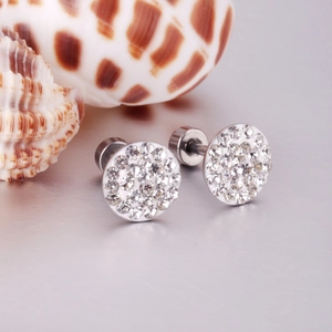 Detailed macro view of crystal-studded round screw back earrings in stainless steel