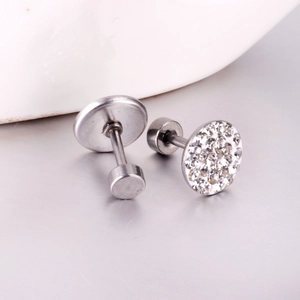 Macro view of silver tone round screw-back earrings with sparkling pavé crystal details