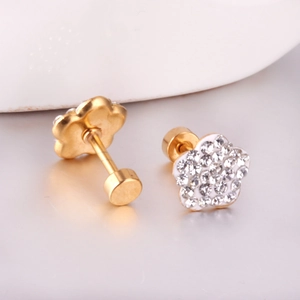 Macro detail of gold floral stud earrings featuring crystal pave and screw back closure