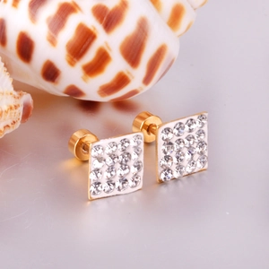 Detailed close-up of golden square stud earrings with pave-set white crystals and disk backings