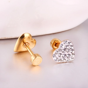 Macro shot of gold heart stud earrings with cubic zirconia and screw-back closure