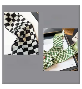 Detail of checkerboard scarf showing neat inner seam edges and smile pattern print