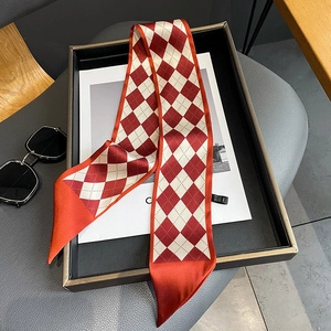 Macro detail of red and white argyle pattern silk twilly scarf for styling