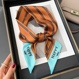 Classic caramel orange skinny scarf with black stripes and blue Happy crown accent