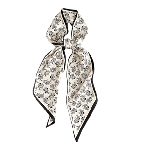 Elegant black and white Paisley narrow silk scarf presented in a tied bow style