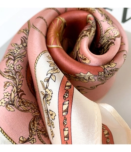 Detailed macro view of pink floral silk scarf featuring vintage baroque patterns