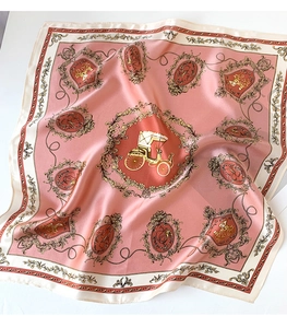 Detailed view of pink silk scarf with vintage carriage pattern and baroque golden motifs