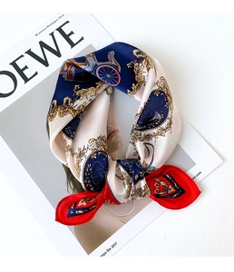 Detailed close-up of retro horse carriage silk scarf tied on a white magazine background