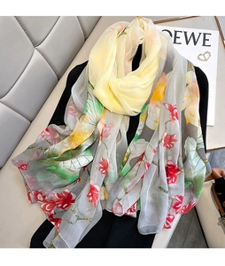 Detailed view of lightweight lotus pattern silk scarf with ink wash floral design