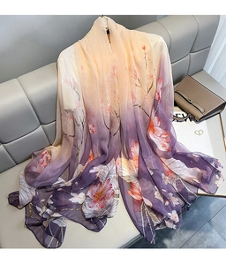 Close-up of lightweight chiffon scarf with orange-purple gradient and floral print