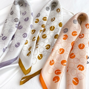 Detailed macro view of purple, olive and orange silk scarves with abstract ring patterns