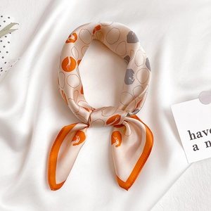 Elegant champagne silk square scarf with geometric polka dot pattern and orange trim decor
