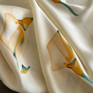 Elegant silk scarf featuring realistic calla lily floral print in a draped satin texture