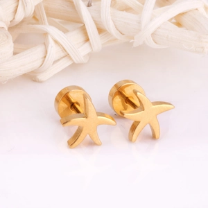 Macro shot of polished gold starfish stud earrings with a glossy metal finish