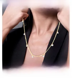 Close-up of gold stainless steel necklace with waterdrop crystals on a model