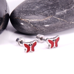 Macro view of red enamel butterfly stud earrings with secure screw-back closures