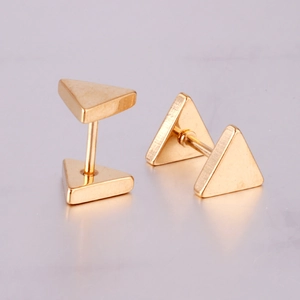 Macro shot of minimalist gold triangle stud earrings with a polished metal finish